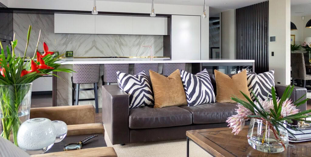 Modern living room with stylish decor and marble kitchen