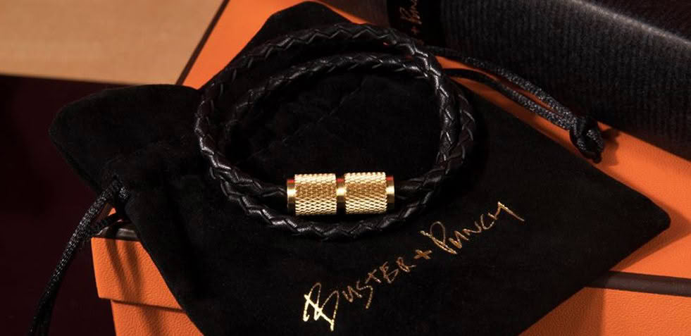 Designer braided leather bracelet with gold accents on display