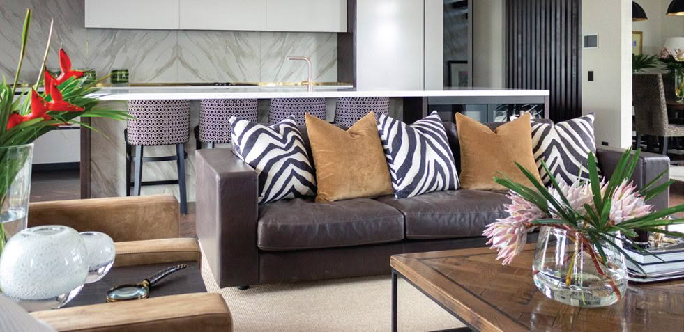 Modern living room with stylish furnishings and marble kitchen