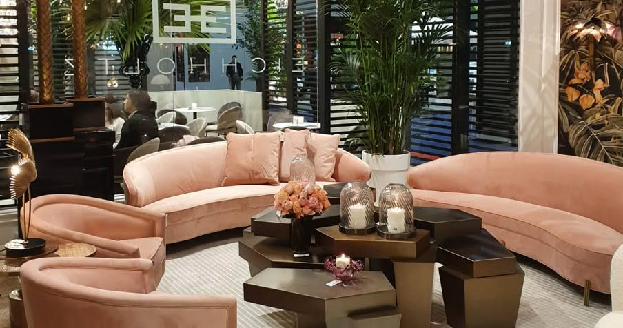 Elegant hotel lobby with pink sofas and chic decor