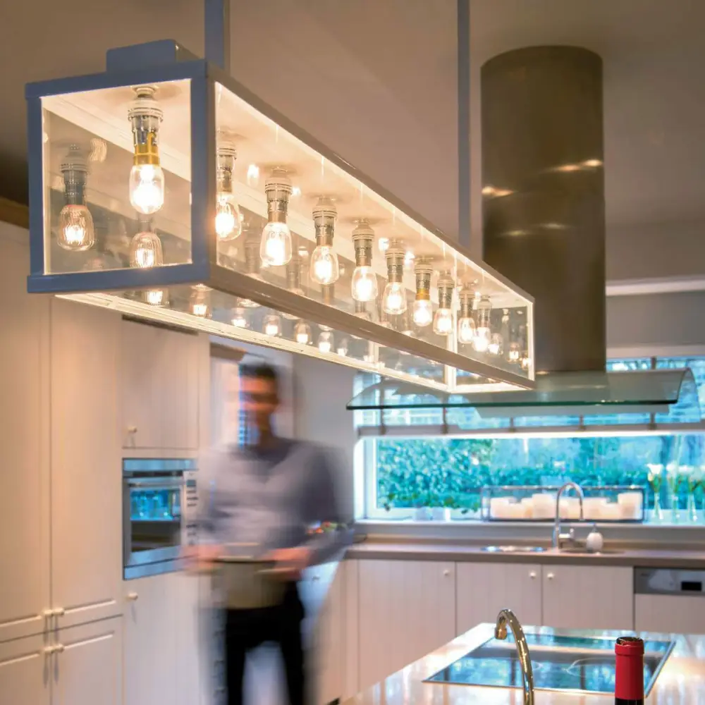 Man blurred in modern kitchen with unique light fixture