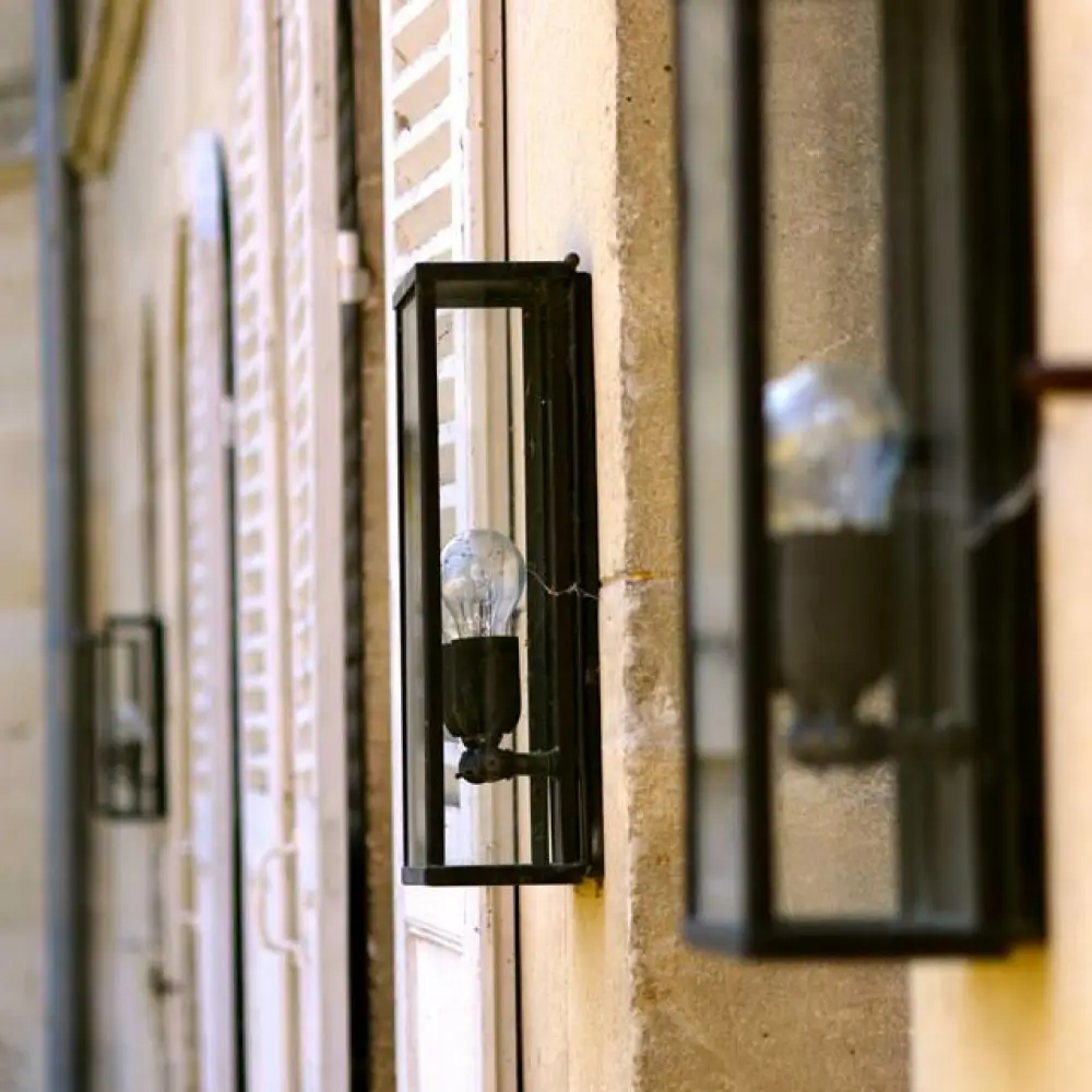 Street lamps on building facade in narrow alley