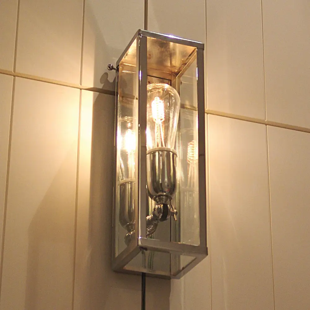 Illuminated rectangular wall-mounted light fixture in bathroom