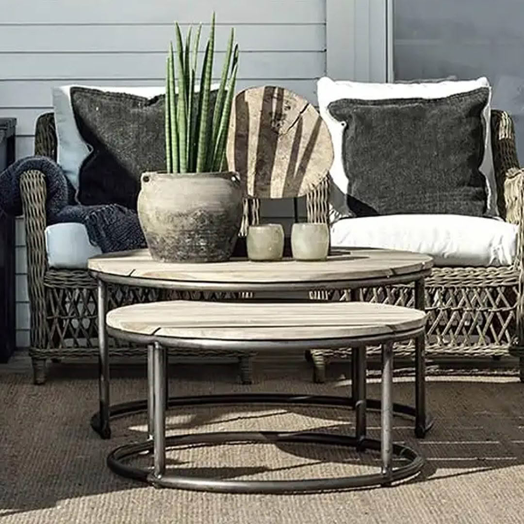 Cozy outdoor seating area with wicker chairs and plants