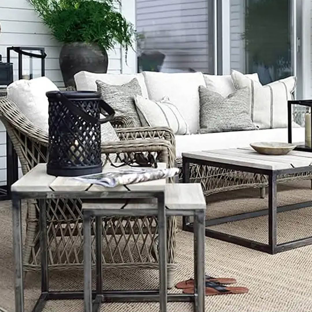 Elegant outdoor patio setup with wicker furniture and cushions