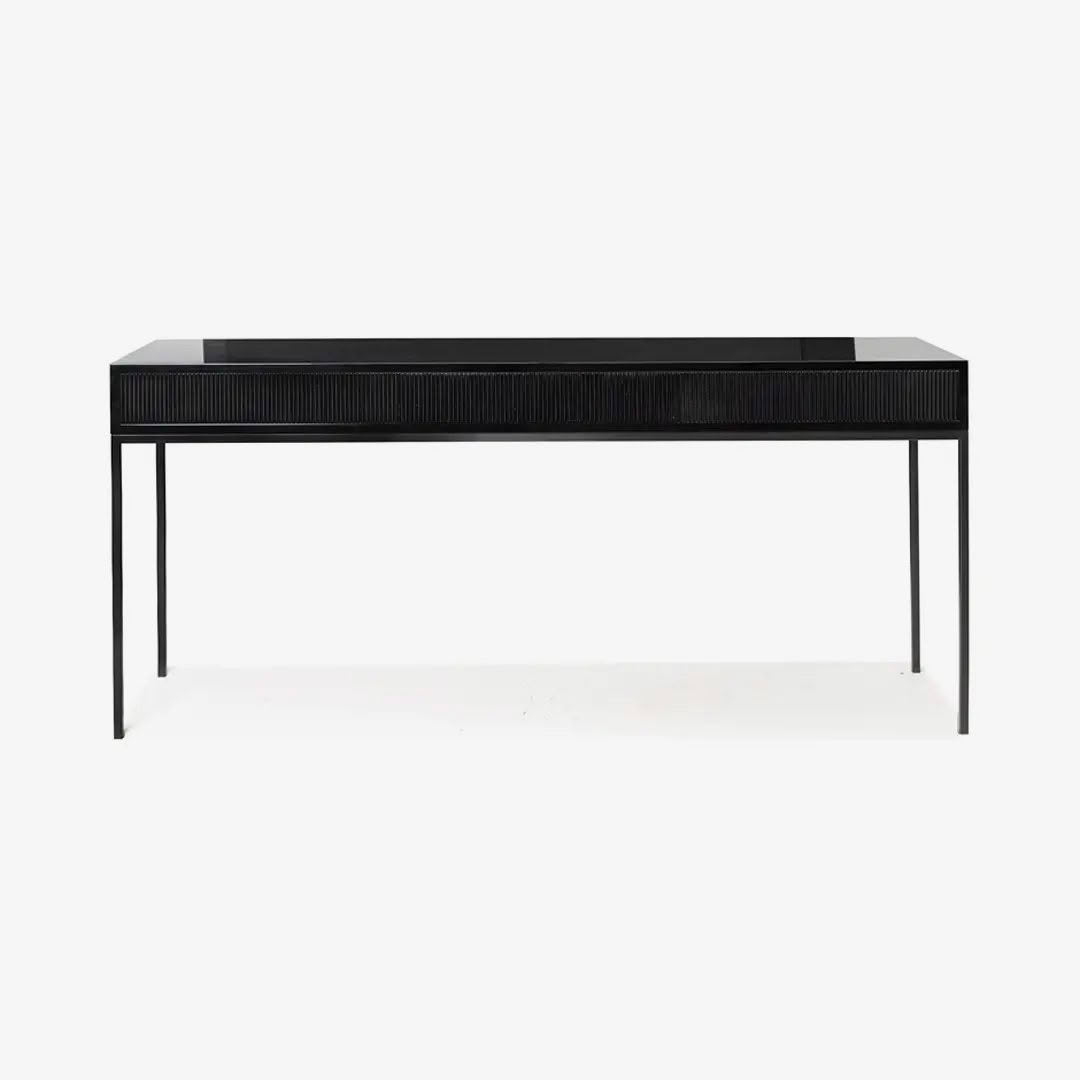 Black modern desk with textured drawers on white background