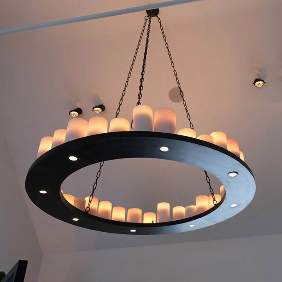 Modern circular chandelier with lit candles and LEDs