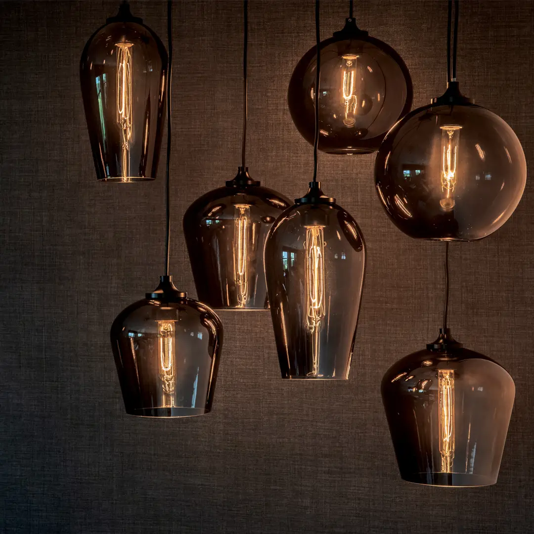 Stylish amber glass pendant lights against a textured backdrop