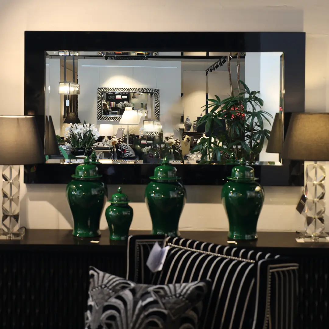 Elegant interior decor with mirrors and green vases