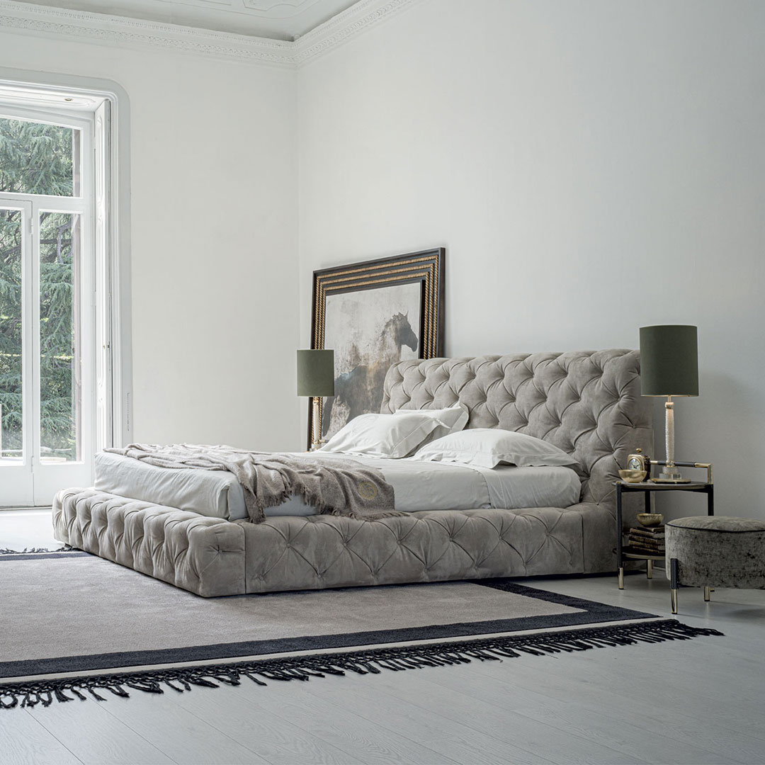 Elegant bedroom with tufted bed and minimalist decor