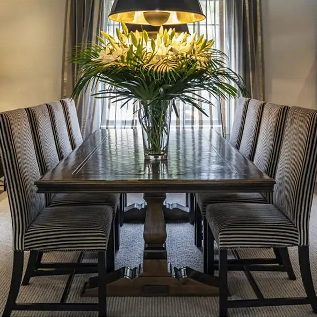 Elegant dining room with striped chairs and floral centerpiece