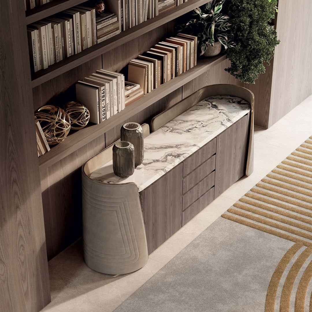 Modern bookshelf with marble-top cabinet and decorative vases.
