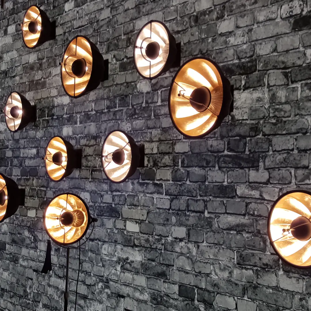 Vintage lamps on textured brick wall