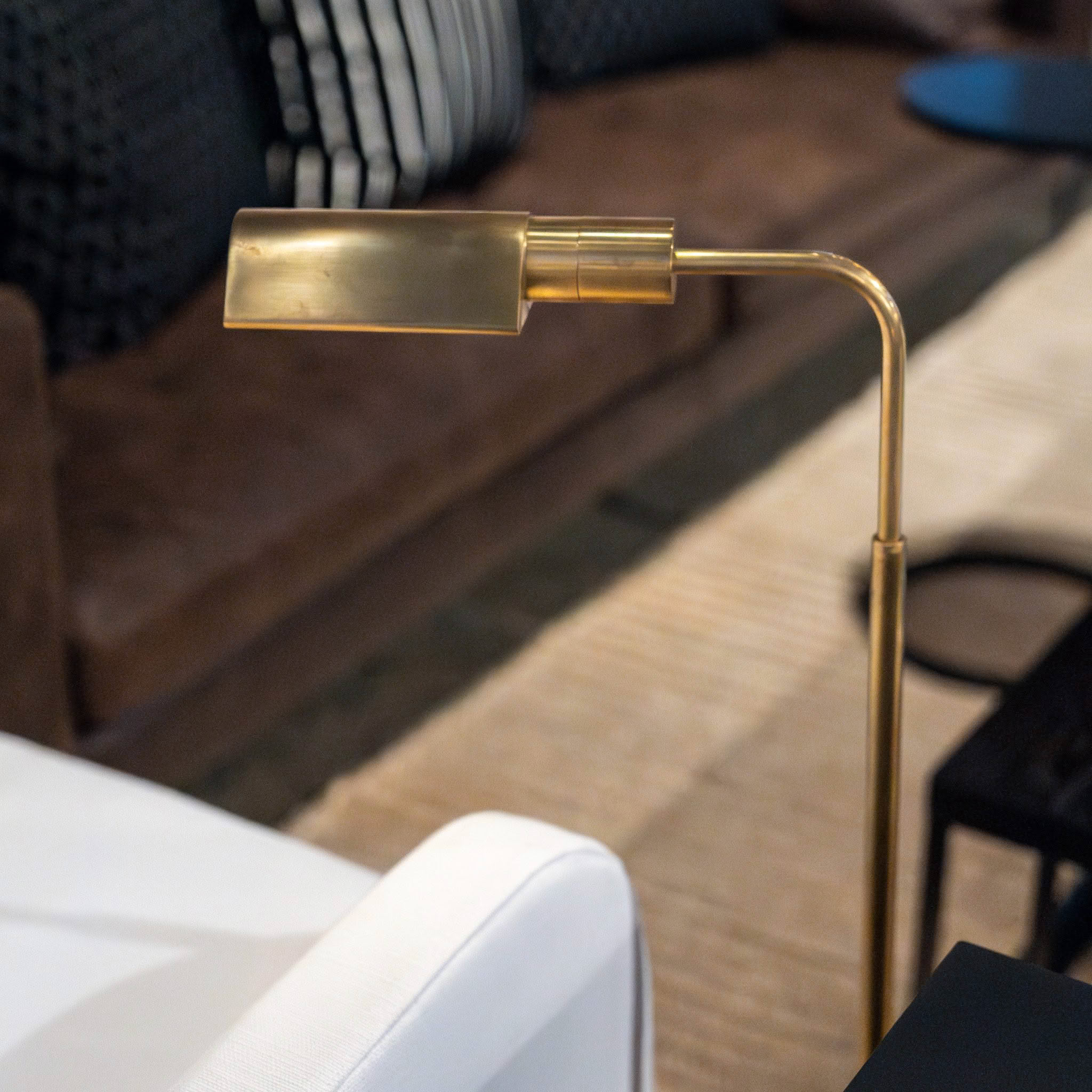 Elegant brass reading lamp over cozy chair