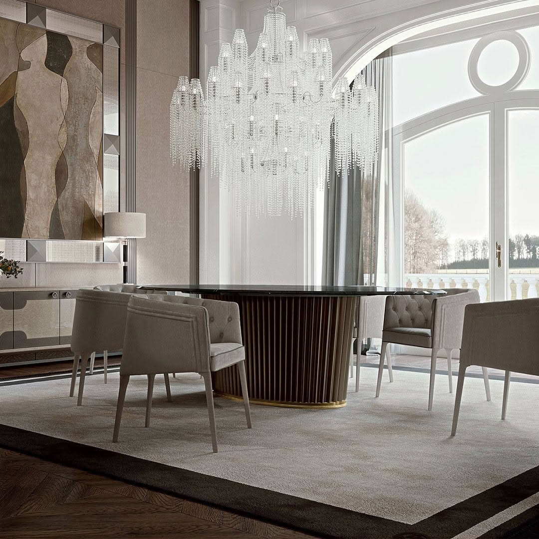 Luxurious dining room with opulent chandelier and lake view