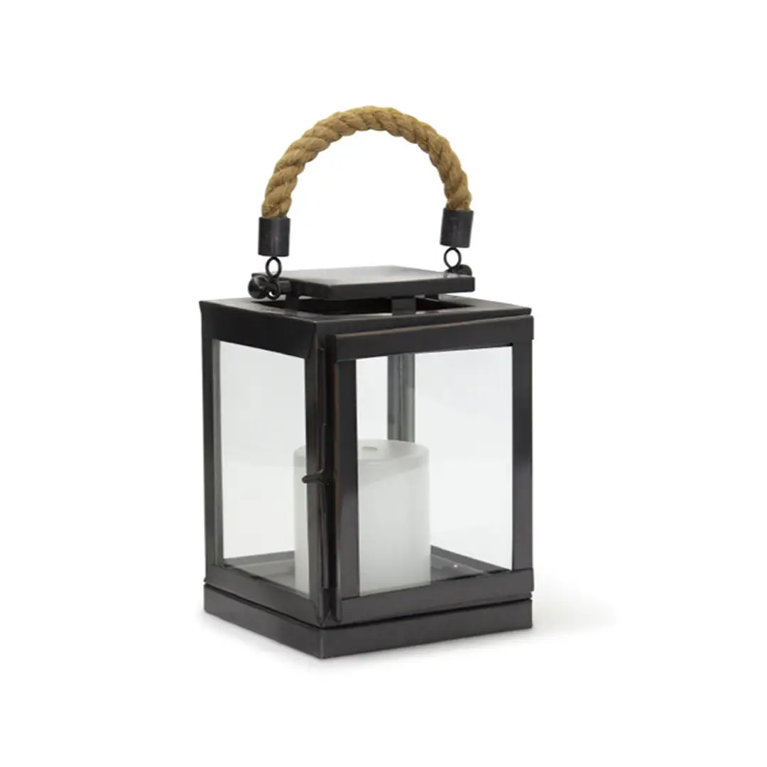 Black lantern with rope handle and white candle inside