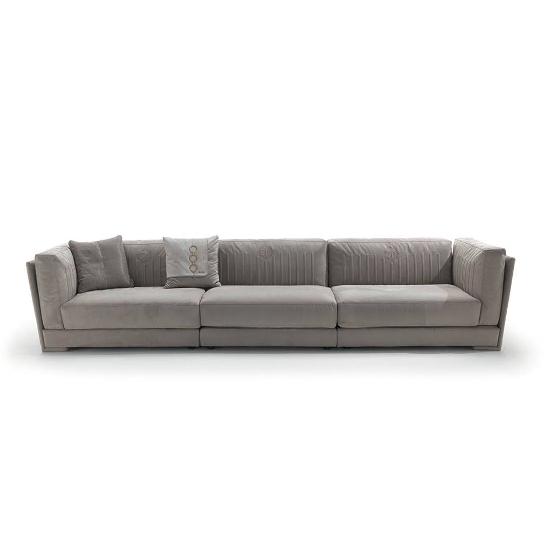 Gray sectional sofa with cushions on white background