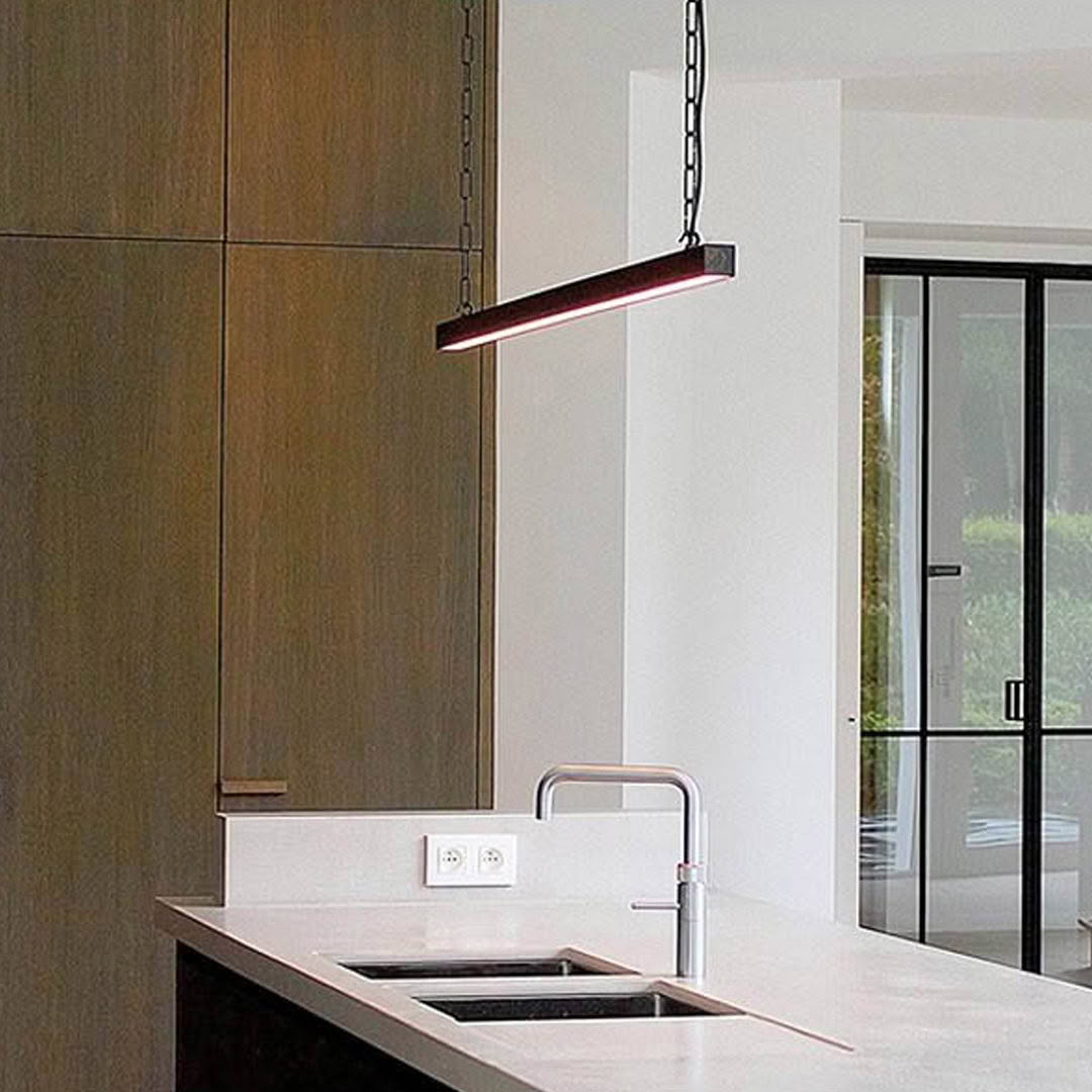 Modern kitchen with sleek suspended light fixture
