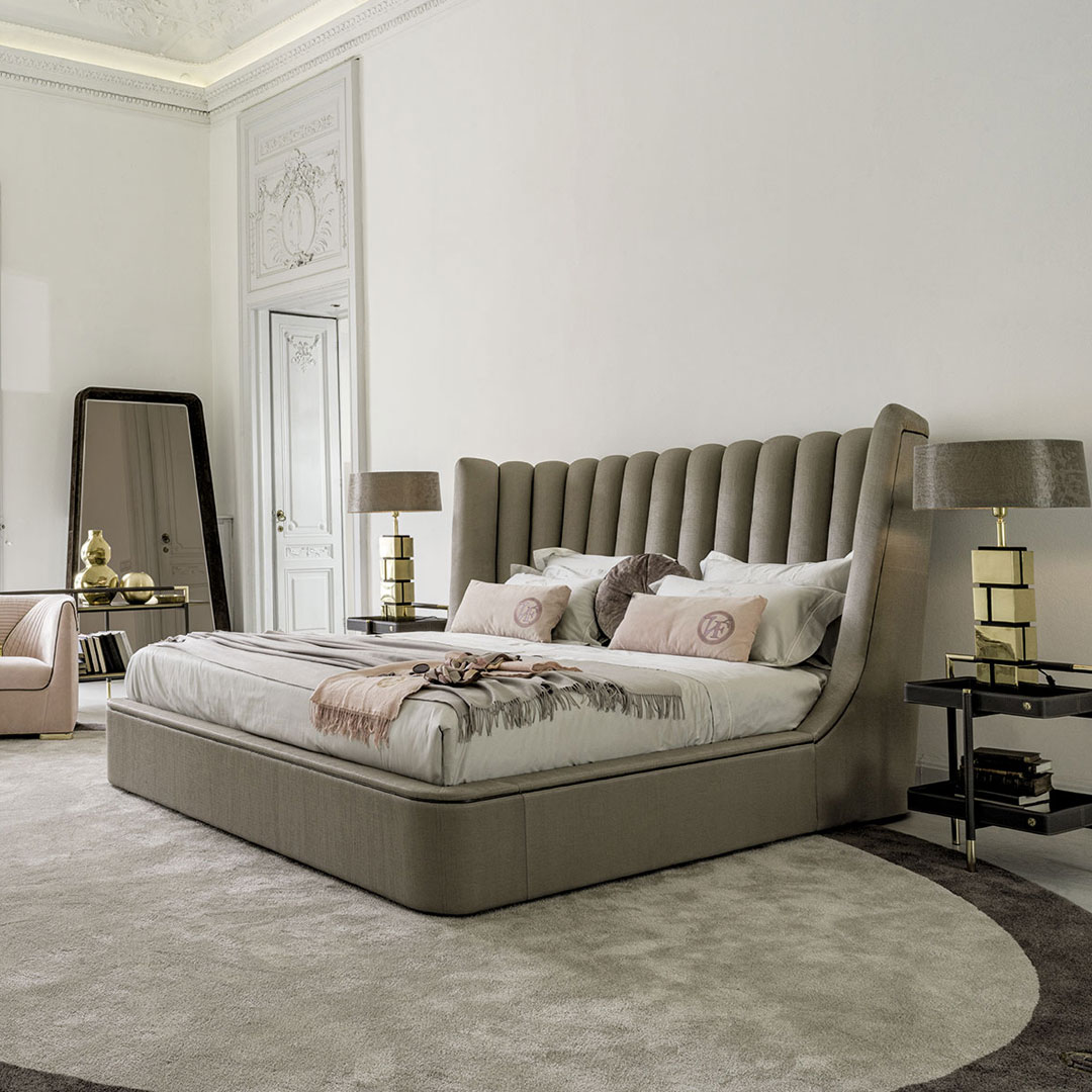 Elegant bedroom with large tufted headboard and stylish decor