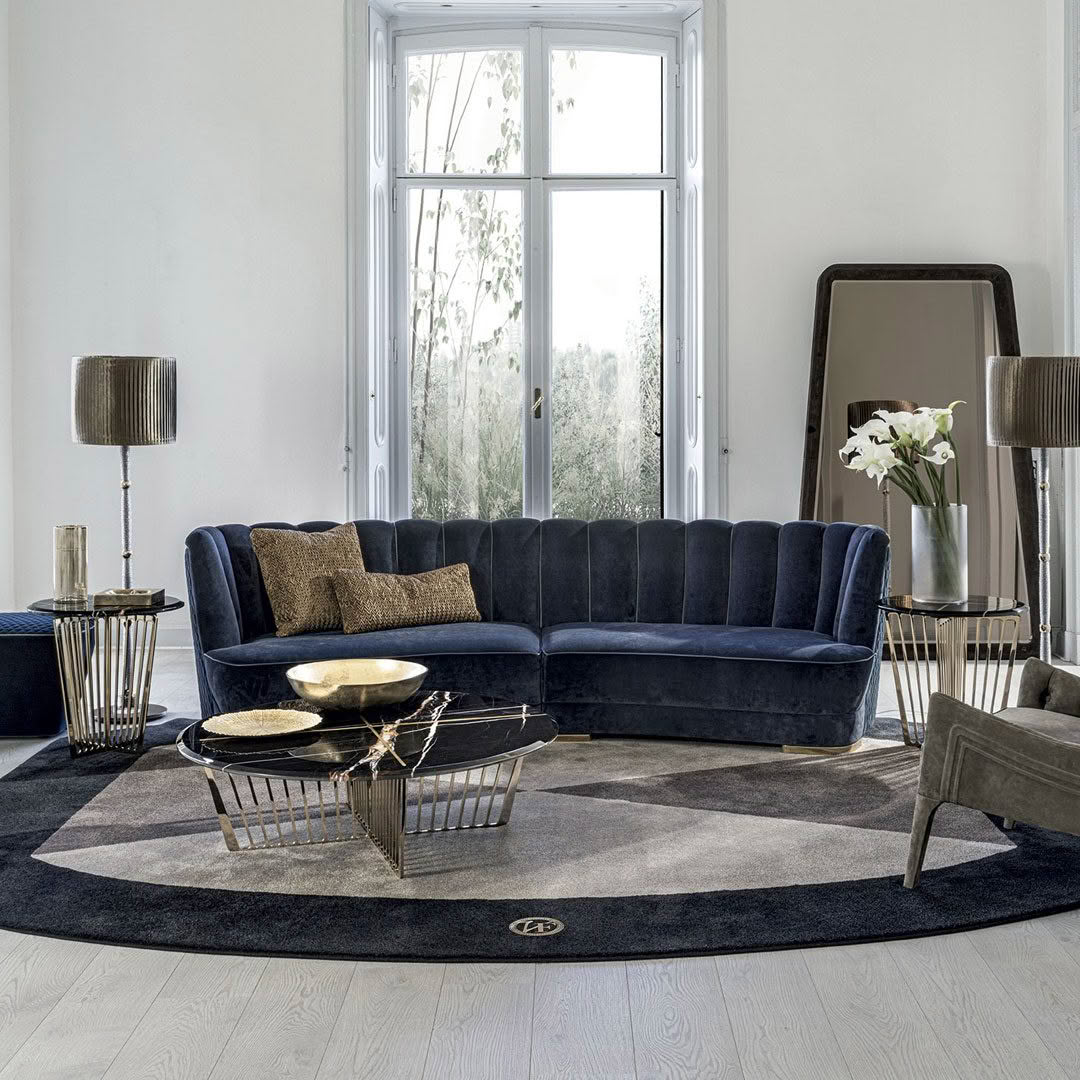 Elegant living room with blue velvet sofa and large window