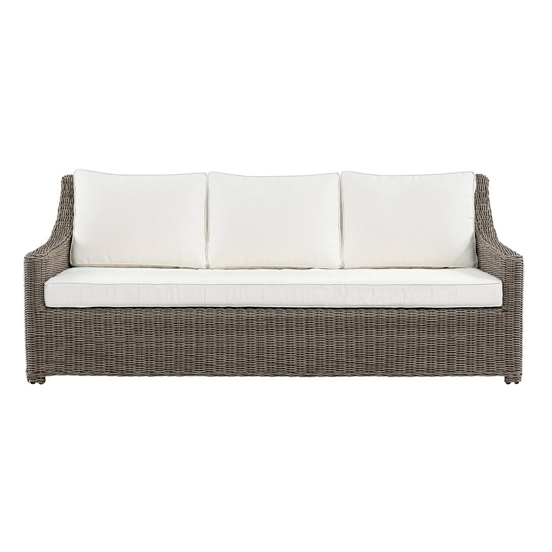 Wicker outdoor sofa with white cushions