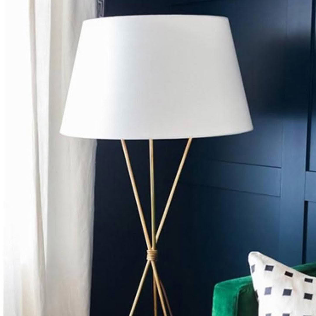 Elegant floor lamp with white shade and gold tripod base