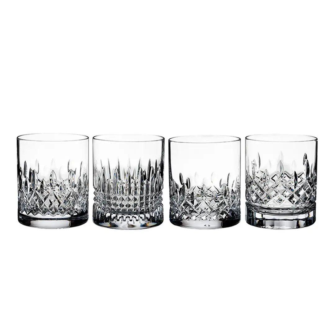 Four crystal whiskey glasses with intricate designs