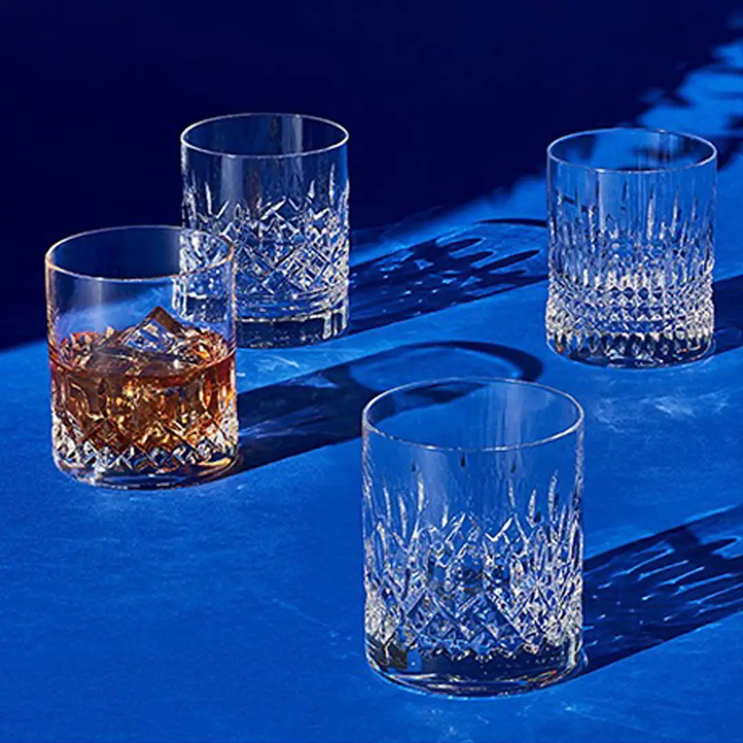 Crystal whiskey glasses on blue backdrop