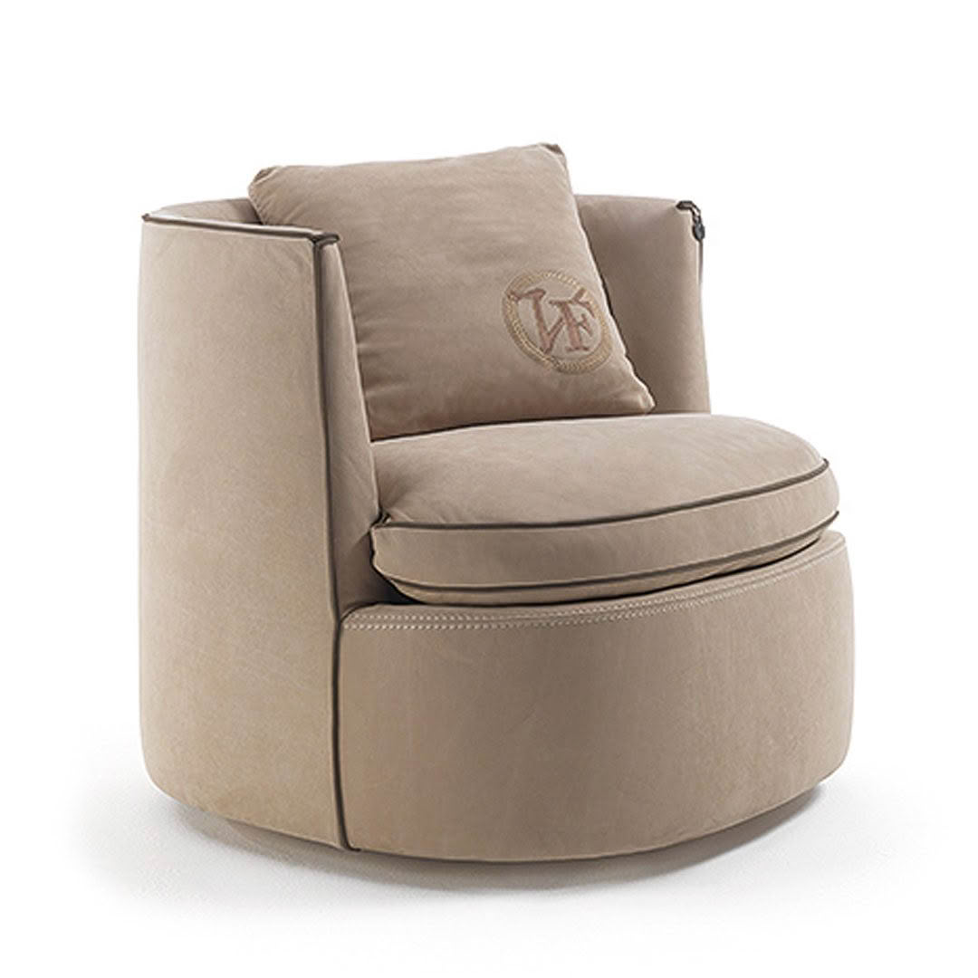 Tan swivel chair with embroidered cushion