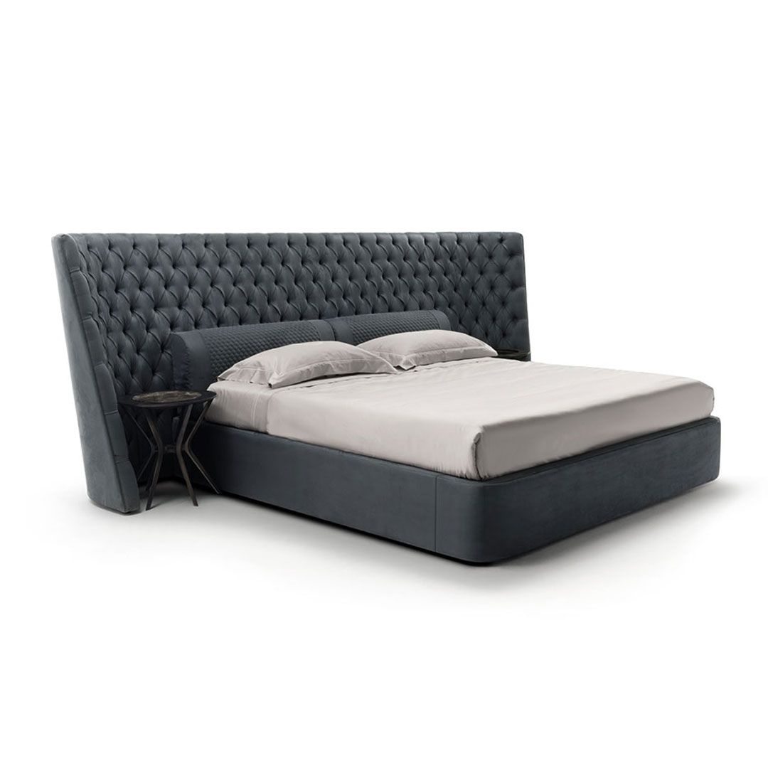 Elegant tufted gray upholstered king-size bed with side table.