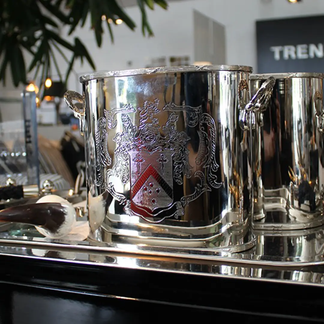 Silver ice bucket with ornate crest design