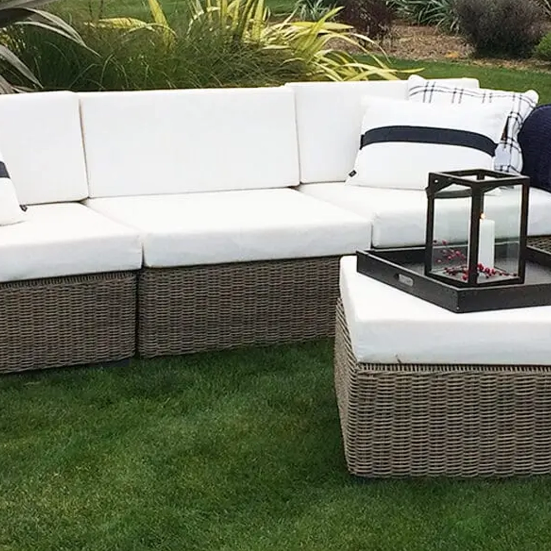 Outdoor sectional sofa with white cushions and lantern