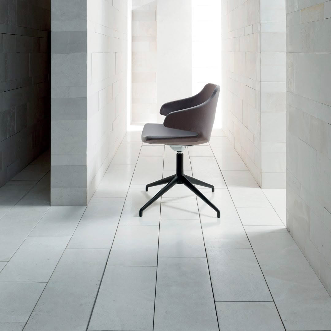 Modern chair in sunlit tiled minimalist room