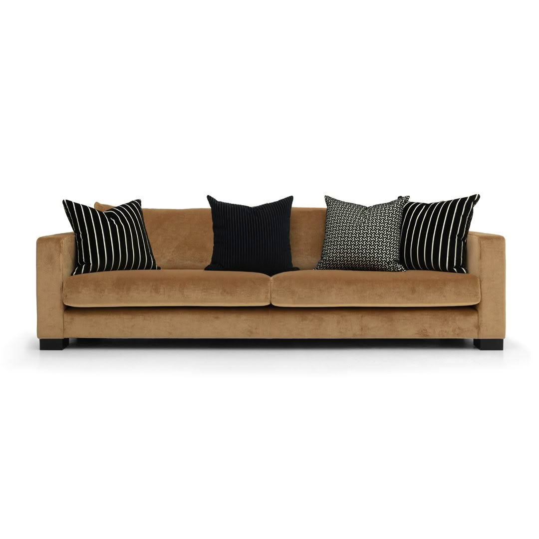 Tan sofa with black striped and patterned pillows