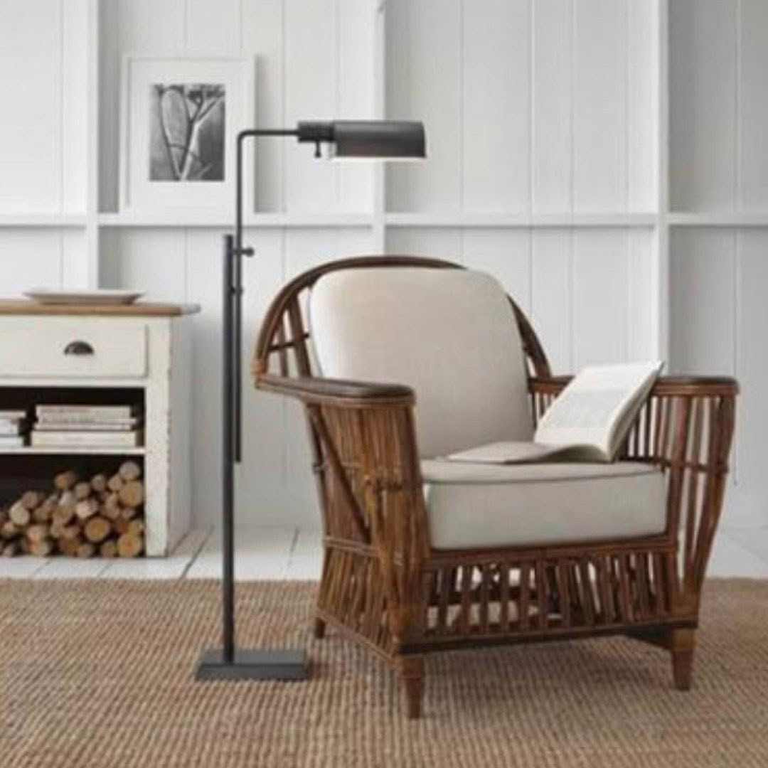 Cozy reading nook with rattan chair and floor lamp