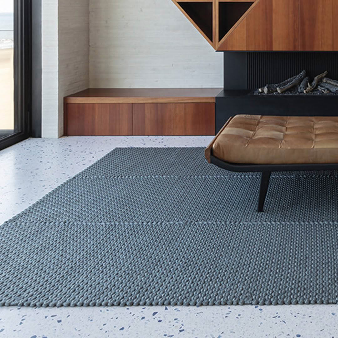 Modern living room with stylish gray rug and furniture