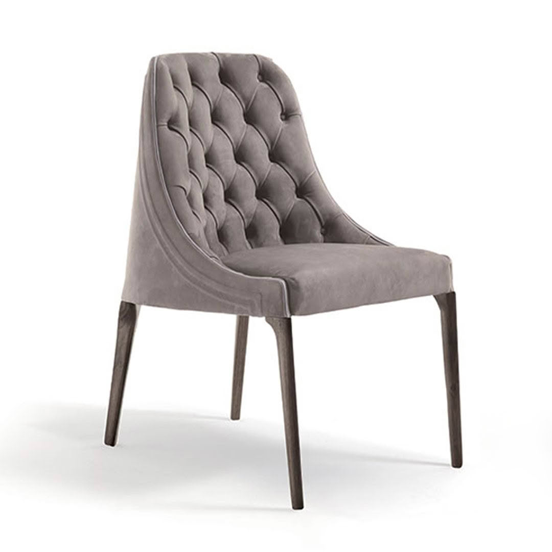 Elegant gray tufted dining chair on white background