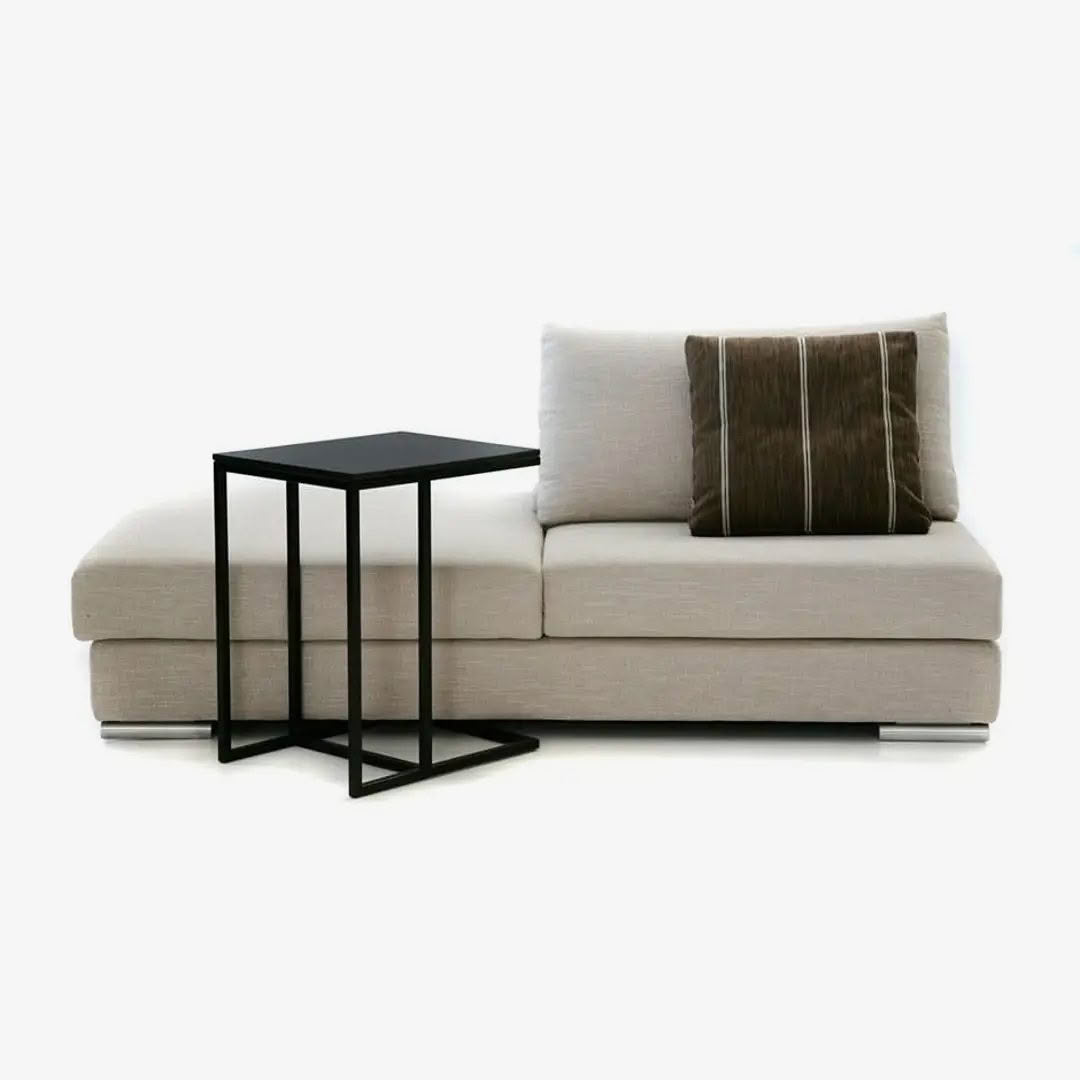 Modern beige sofa with black side table