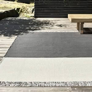 Outdoor textured rug on wooden patio deck