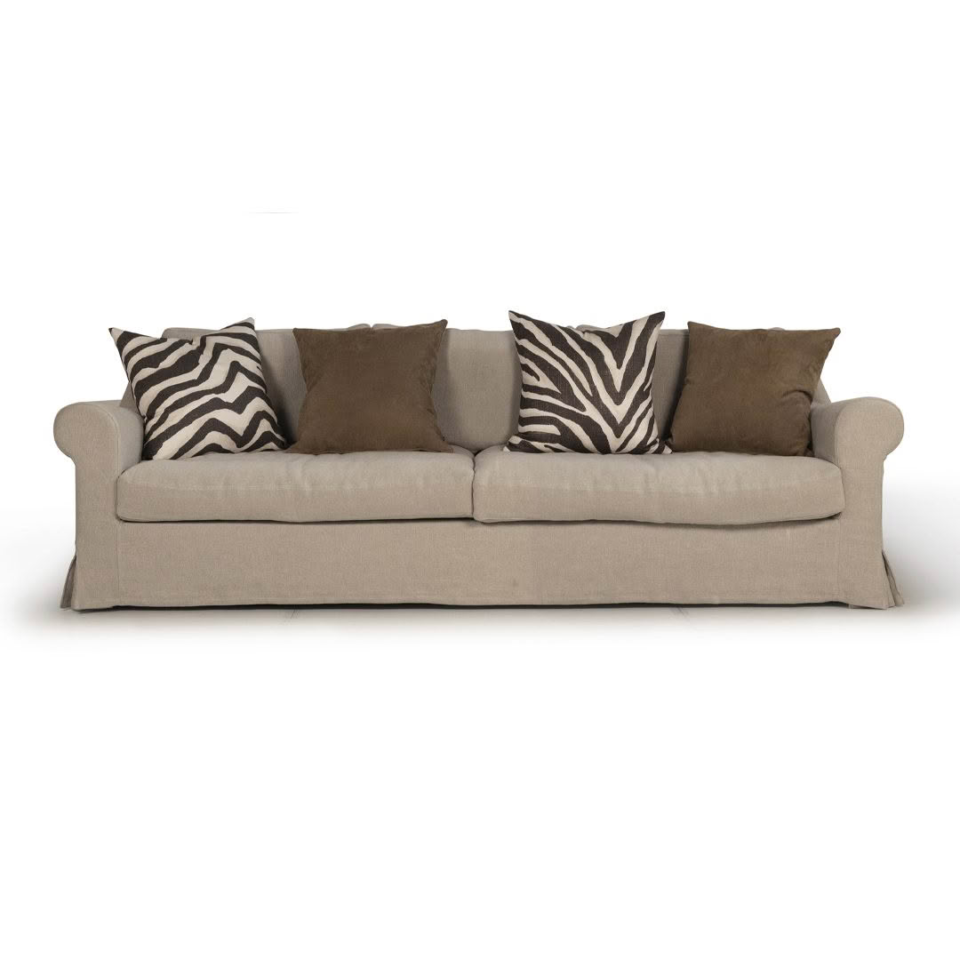 Beige sofa with zebra and brown pillows isolated