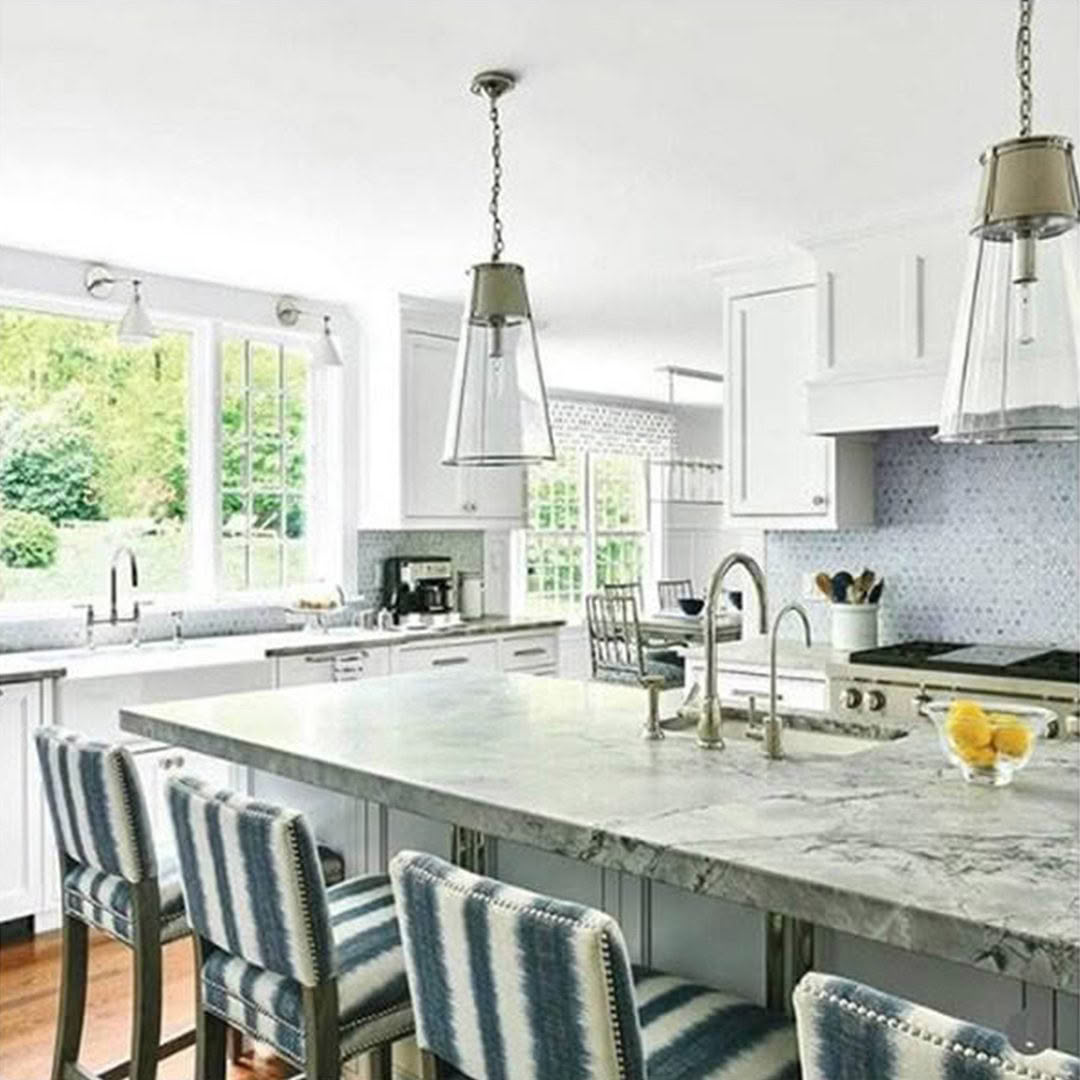 Bright modern kitchen with striped bar stools and pendant lights