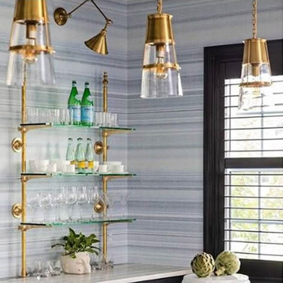Elegant brass bar cart with glass shelves and pendant lights