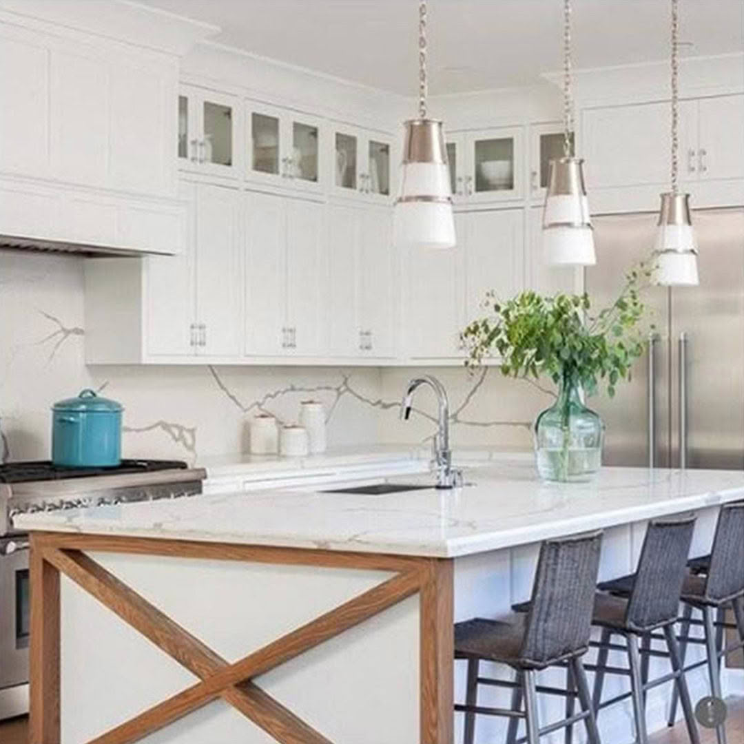 Modern white kitchen with pendant lights and bar stools
