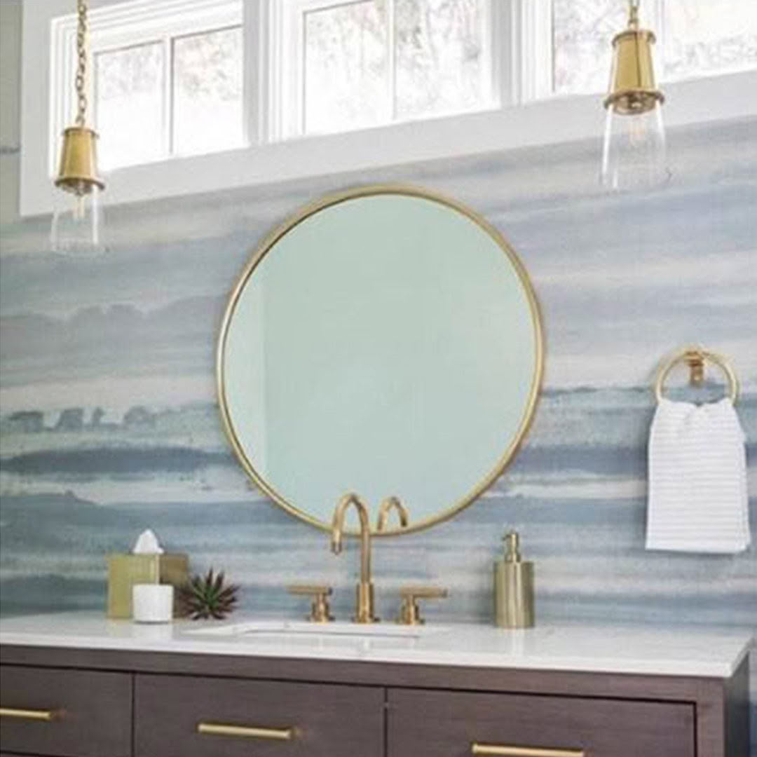 Modern bathroom with round mirror and wave-patterned backsplash