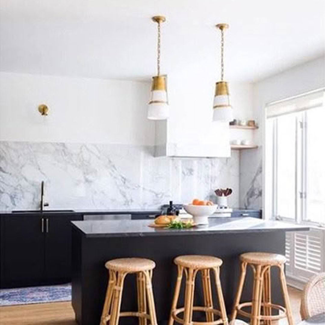 Modern kitchen with marble backsplash and pendant lights