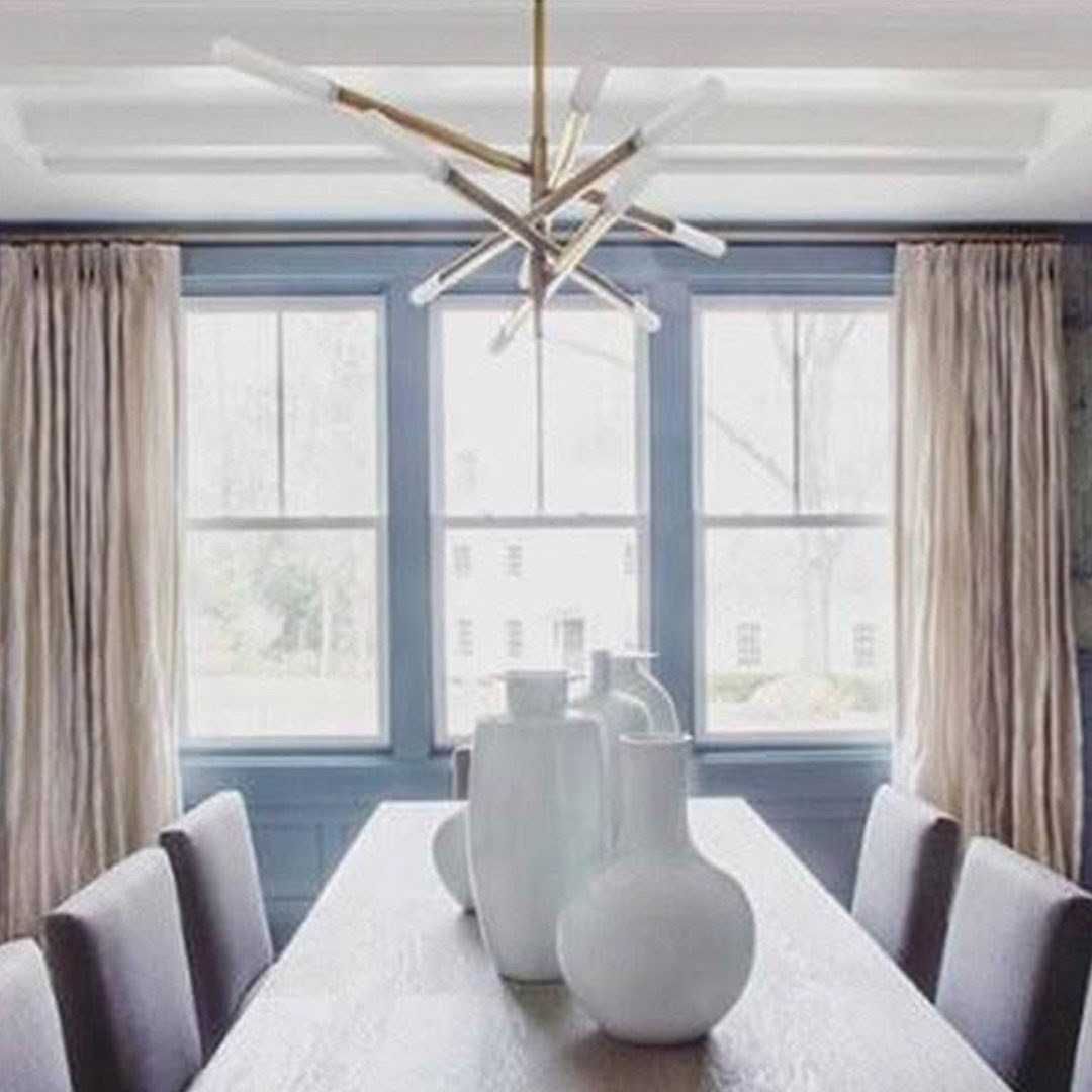 Elegant dining room with modern chandelier and window view