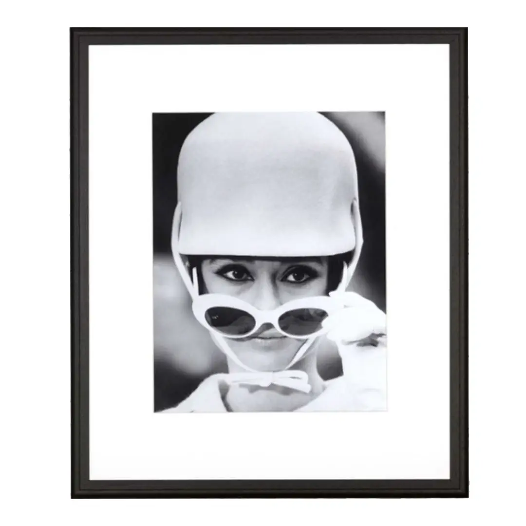 Vintage portrait of woman in helmet and round sunglasses.