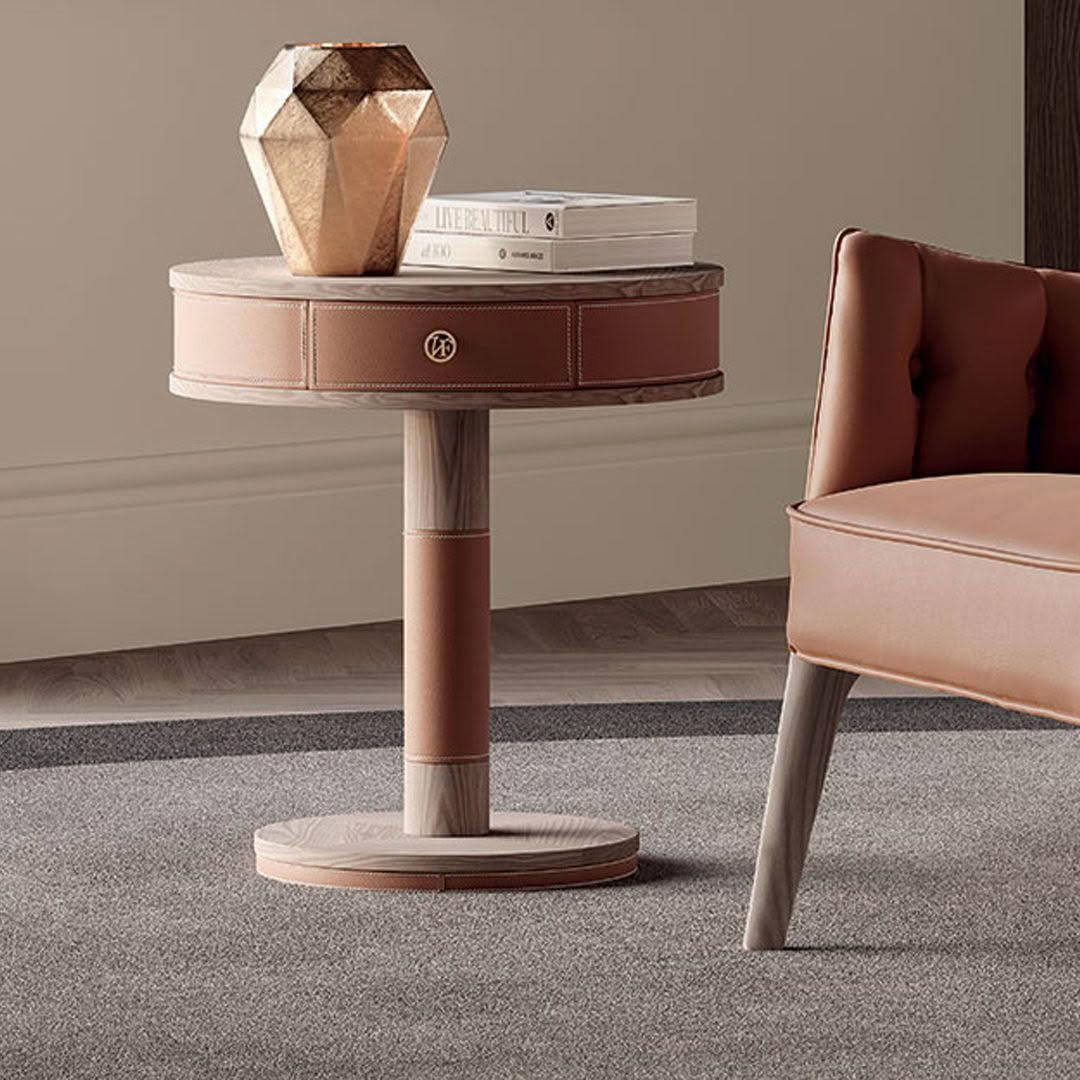 Elegant round side table with books and geometric sculpture