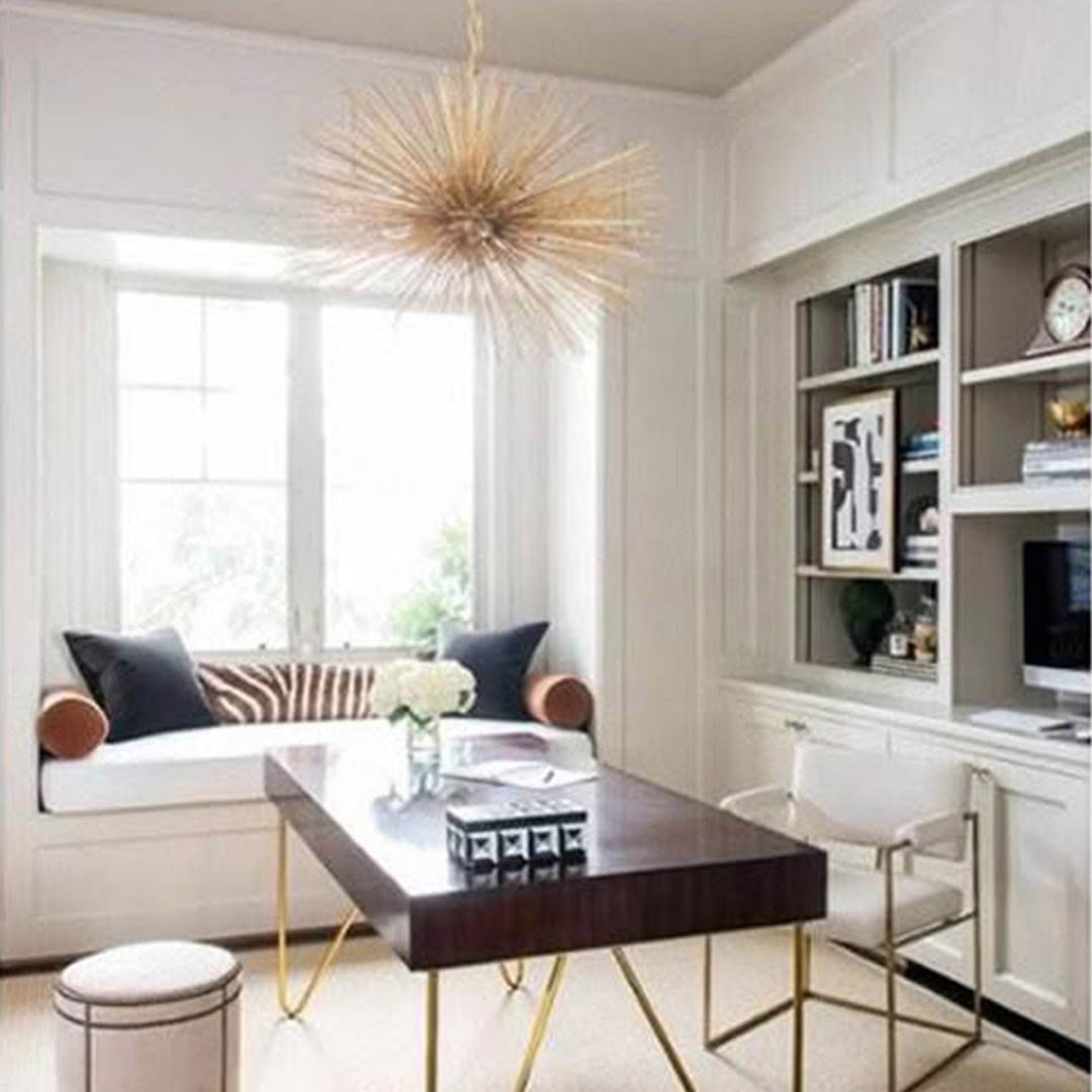 Elegant home office with starburst chandelier and built-in shelves