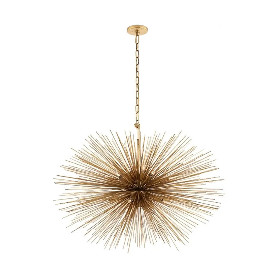 Gold starburst chandelier hanging against a white background